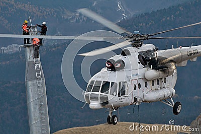 Three thumping assemblers under the helicopter Editorial Stock Photo