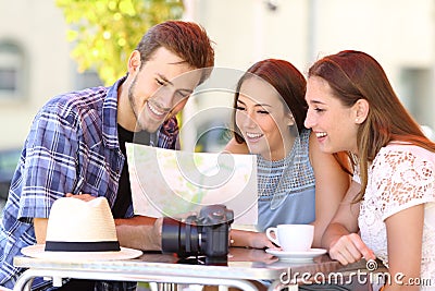 Three tourists planning travel in a bar Stock Photo