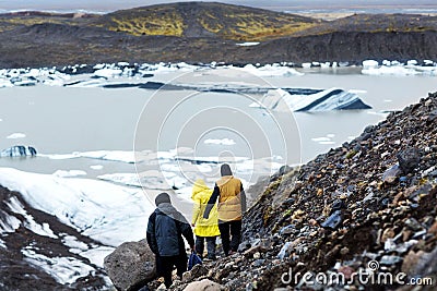 Three tourists will be on an iceberg in Iceland Stock Photo