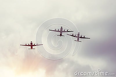 Three turboprop bombers fly in the gray sky Stock Photo