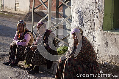 Three Turkish women on the sidewalk in a village Editorial Stock Photo