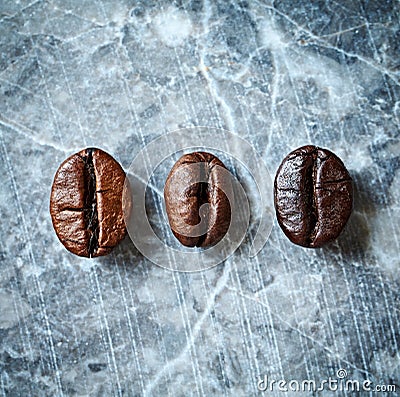Three types of coffee beans on a marble background Stock Photo