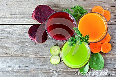 Three types of healthy vegetable juice above view on wood Stock Photo