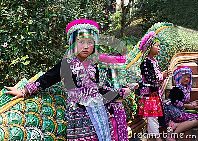 Three unidentified Akha children pose for tourist photos at Wat Phratat Doi Suthep on in Chiang Mai, Thailand. Editorial Stock Photo