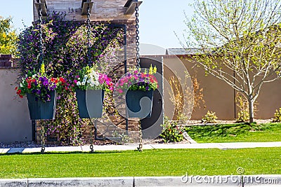 Three Unique Flower Containers Suspended By Chains Stock Photo