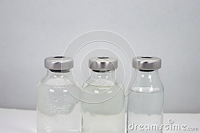 Three Vaccine vials against virus Stock Photo