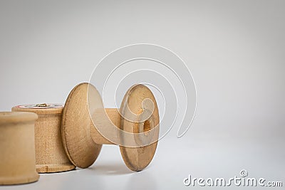 Three vintage empty wooden cotton reels. Stock Photo