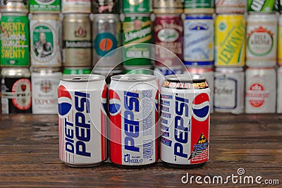 A row of vintage Pepsi aluminium cans with the cans background located on the wooden table. Pepsi is a one of the most popular Editorial Stock Photo