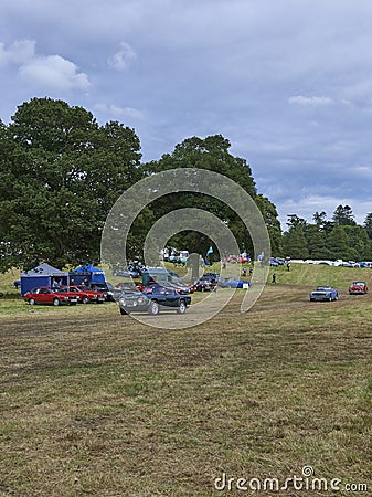 Three Vintage Triumph Cars being driven across the Show Field at the Strathmore Vintage Vehicle Show. Editorial Stock Photo