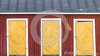 Three vintage yellow doors in a red wooden house Stock Photo