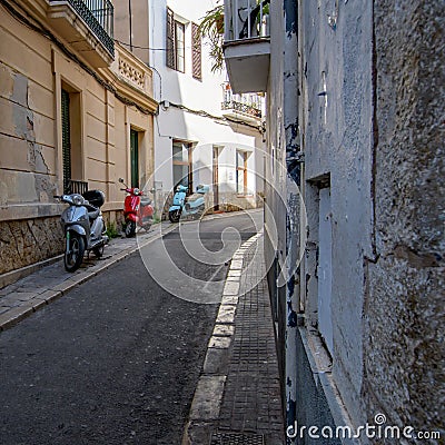Three Vivid scooters parked up a charming little alley in Spain. Editorial Stock Photo