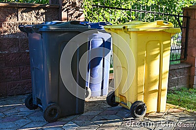 Three waste bins for mixed waste are in the yard Stock Photo