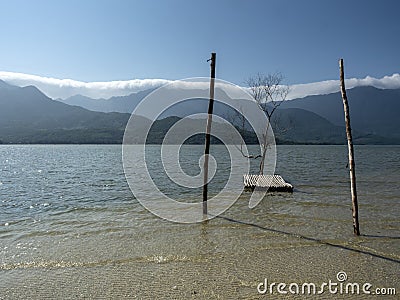 Three in the water with moutains in the backgroud Stock Photo