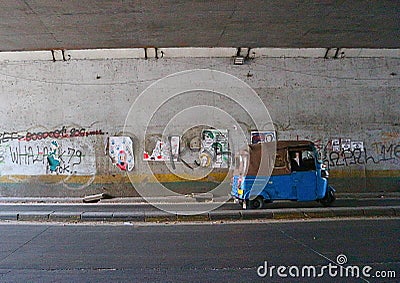 three-wheeled motorcycle under the bridge Editorial Stock Photo