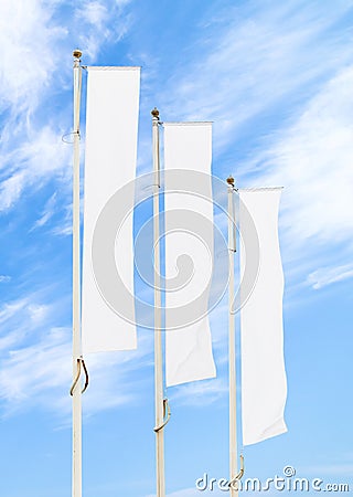 Three white corporate flags mockup against blue sky Stock Photo