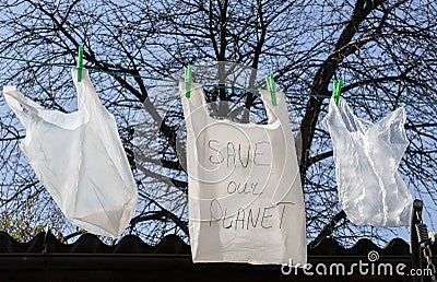Three plastic bags hang on a wire. Stock Photo