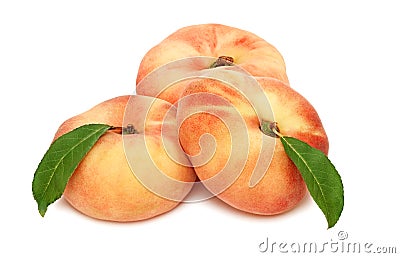 Three whole flat peaches with green leaves (isolated) Stock Photo