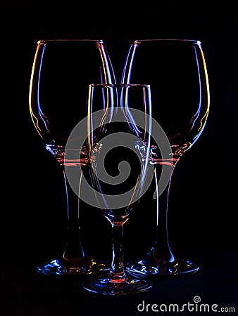 Three wine type glasses, backlit still life with copyspace. Stock Photo