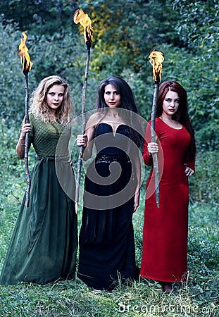 Three witches with with torches Stock Photo