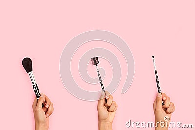 Three woman hands holding make up brushes Stock Photo