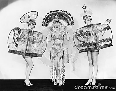 Three woman in ornate teapot costumes Stock Photo