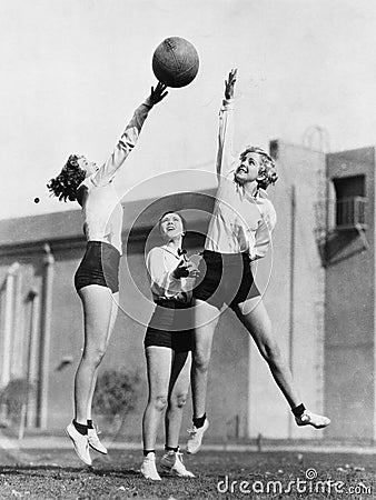 Three women with basketball in the air Stock Photo