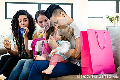 Three women celebrating a babies first birthday Stock Photo