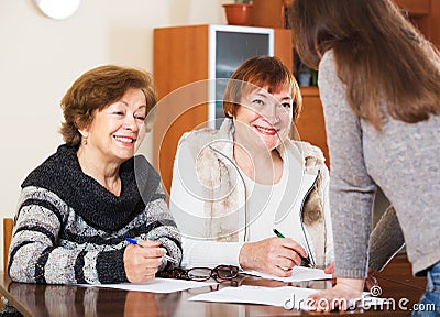 Three women with papers Stock Photo