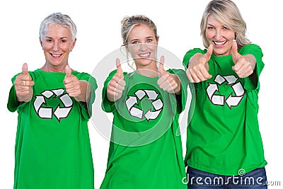 Three women wearing green recycling tshirts giving thumbs up Stock Photo