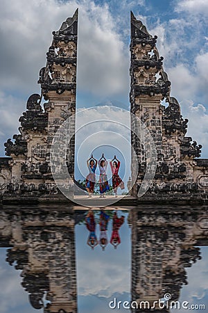 Three women in yoga pose between the gates of Lempuyang temple Editorial Stock Photo