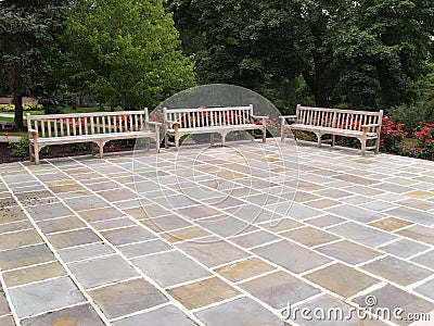 Three wood benches by a patio Stock Photo