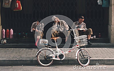 SHANGHAI, CHINA: Three workers break time, resting Editorial Stock Photo