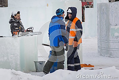 Three workers talking on the construction site Stock Photo