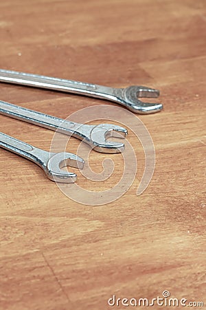 Three wrenches lies on a wooden surface hand tool copy space Stock Photo