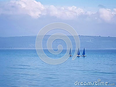 Three yachts on blue sea Stock Photo