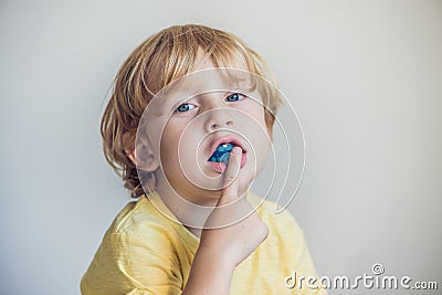 Three-year old boy shows myofunctional trainer to illuminate mouth breathing habit. Helps equalize the growing teeth and correct Stock Photo