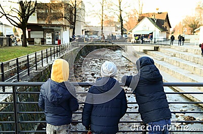 Three young boys on a bridge Stock Photo