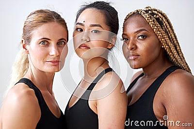 Three young multi ethnic female models of different race, hair colour and body size posing at camera Stock Photo