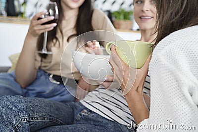 Three young females friends chatting at home Stock Photo