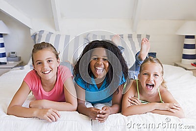 Three Young Friends Lying Down Next To Each Other Stock Photo