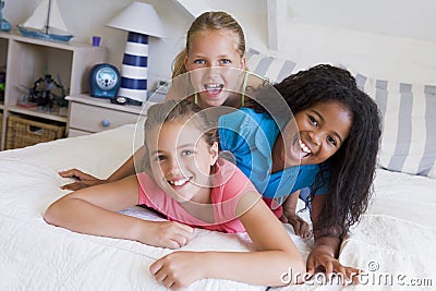 Three Young Friends Lying On Top Of Each Other Stock Photo