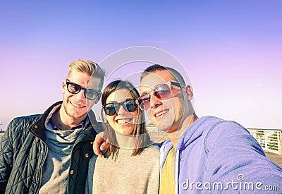 Three young friends taking selfie on sunny autumn day Stock Photo