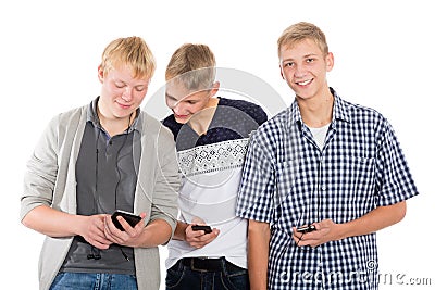 Three young guys use smartphones Stock Photo