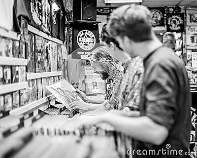 Young men looking at vinyl records in a store or shop. Editorial Stock Photo