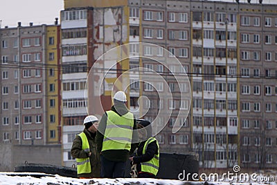 Three young people-an architect at the construction site . Russia Berezniki 23 November 2017 Editorial Stock Photo