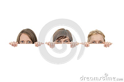 Three young women behind a blank banner ad Stock Photo
