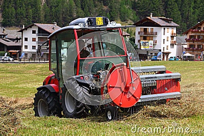 Threshing tractor in action in Cogne on the Sant'Orso meadow..July 29,2023. Editorial Stock Photo