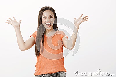 Thrilled expressive cheerful woman with broad smile, screaming from happiness seeing friend returning from foreign Stock Photo