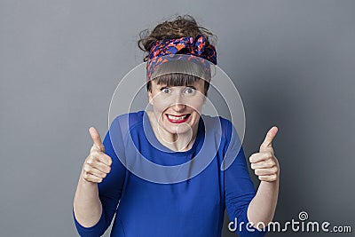 Thrilled retro 30s woman with thumbs up for exciting success Stock Photo