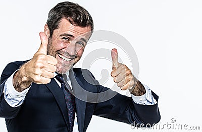 Thrilled smart young businessman with thumbs up approving corporate wellbeing Stock Photo